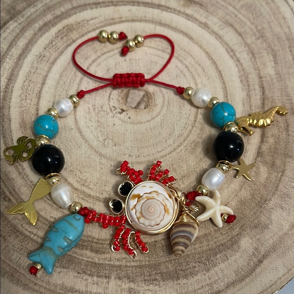 Ocean-Themed Charm Bracelet with Gold and Red Accents